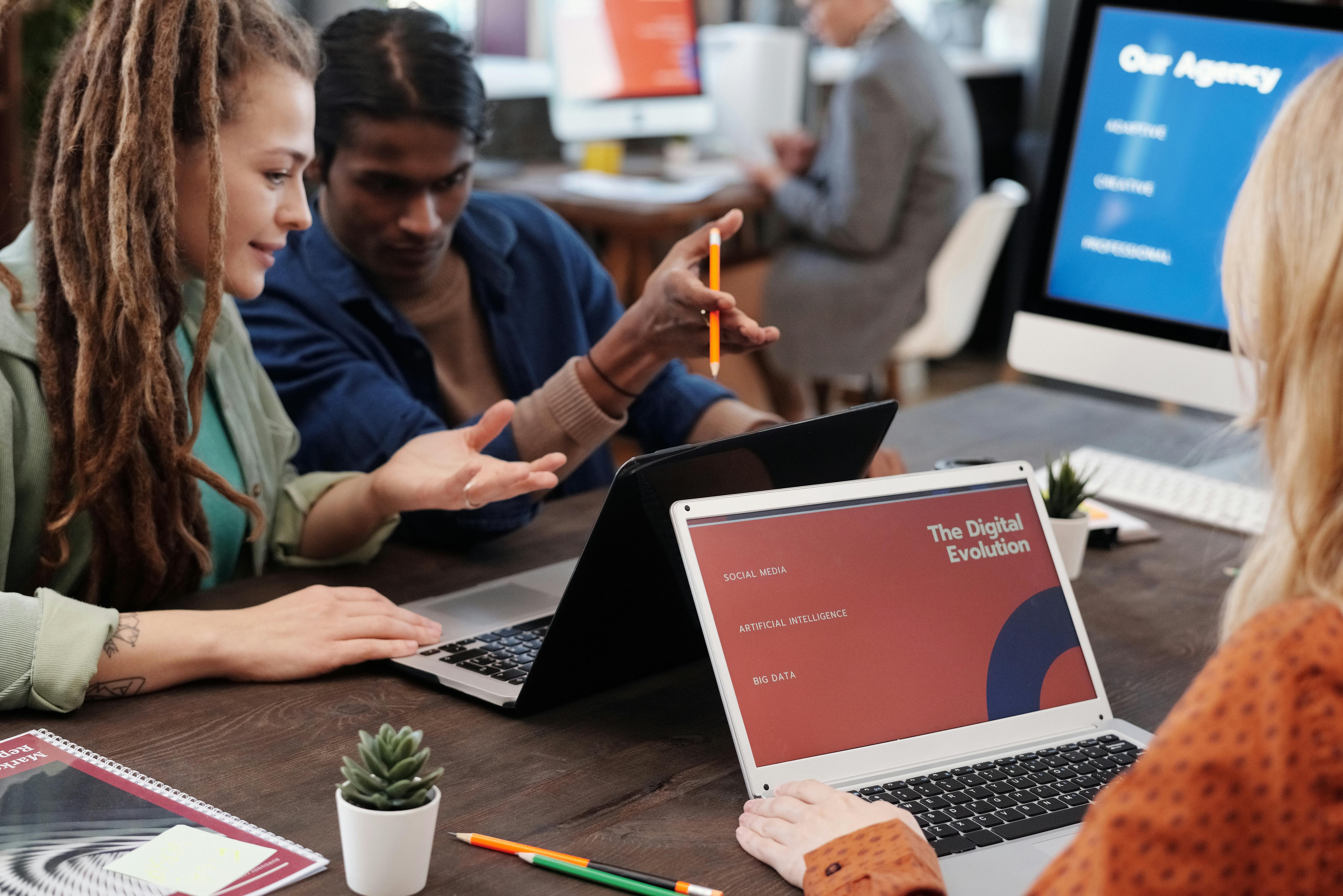 An agency team discussing a digital strategy presentation around a meeting table