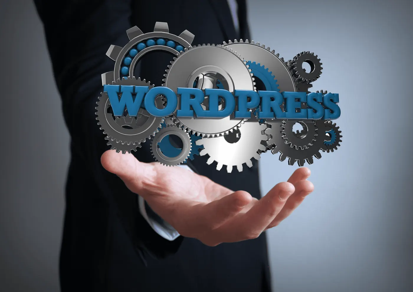 A businessman holding a 3D WordPress logo surrounded by metal cogs