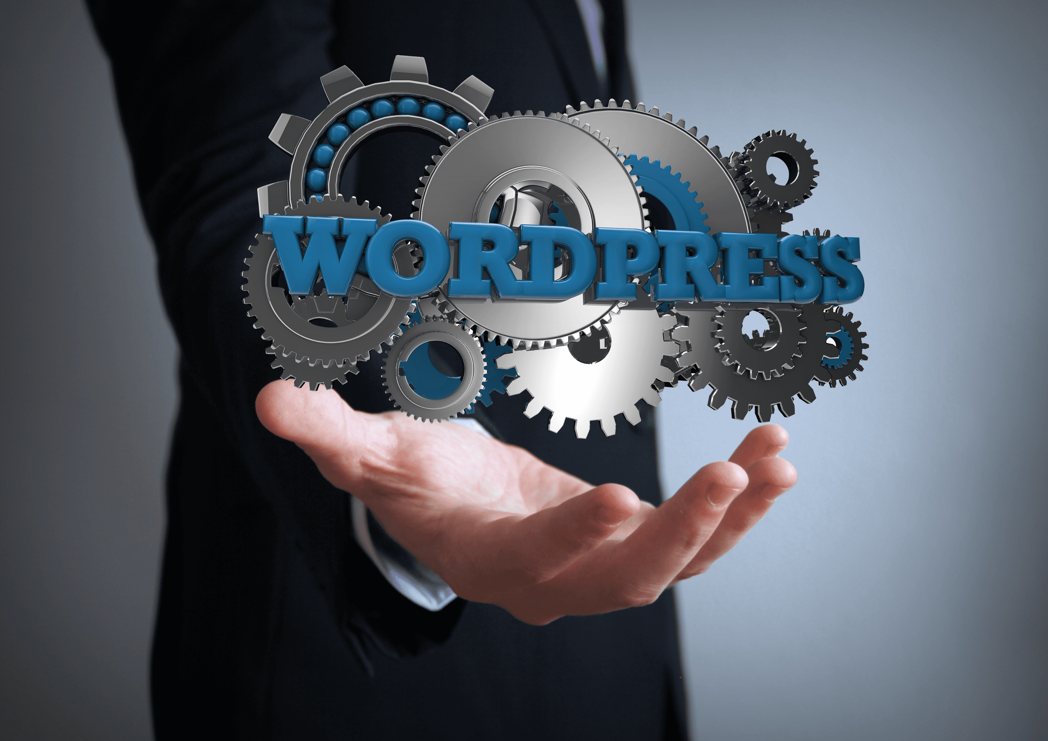 A businessman holding a 3D WordPress logo surrounded by metal cogs